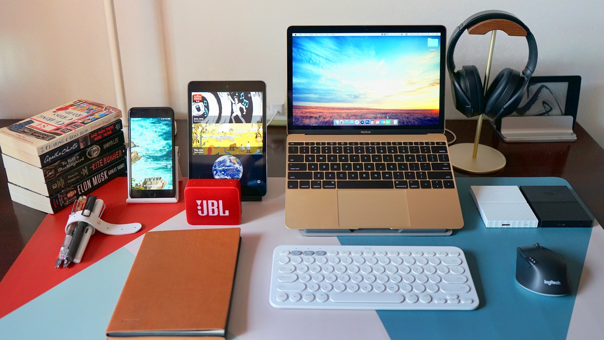 a laptop computer sitting on top of a desk next to a keyboard